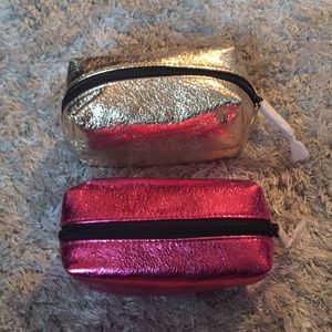 Two small Victoria’s Secret makeup/toiletry bags.